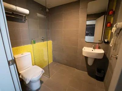 a bathroom with a toilet and a sink at Travelodge Georgetown, Penang in George Town