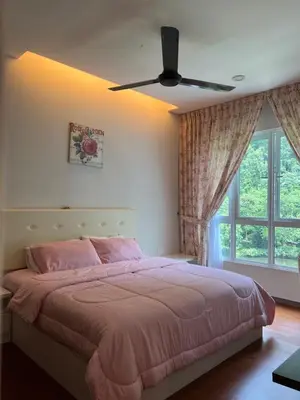 a bedroom with a pink bed with a ceiling fan at Ipoh The Heyven Lakeside Homestay by Quadvanos in Ipoh
