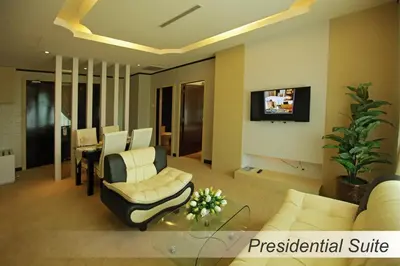 a living room with white furniture and a tv at Casuarina@Meru in Ipoh