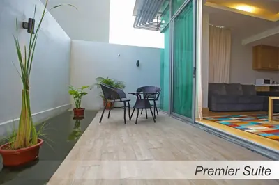 a living room with two chairs and a table at Casuarina@Meru in Ipoh