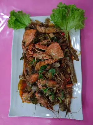 a plate of food with seafood on a pink table at BC Homestay @ Emerald Avenue Apartment, Brinchang in Brinchang