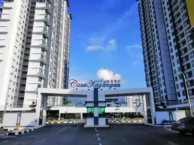 a sign for a parking lot in front of two tall buildings at Lizs Homestay in Ipoh