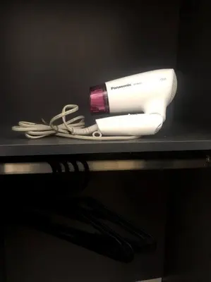 a shelf with a hair dryer and a blow dryer at Queen Room Semi Attached Bathroom Bukit Mertajam Alma Impian in Bukit Mertajam