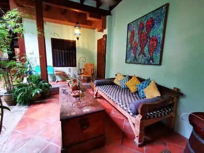 a living room with a couch and a table at East Indies Mansion in George Town