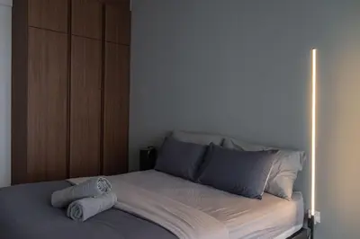 a bedroom with a bed with two towels on it at Large Family Seaview Suite 3 Rooms by The Only Bnb in Tanjong Tokong