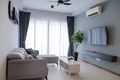 a living room with a couch and a tv at Family Seaview Suite with 3 Rooms by The Only Bnb in Tanjong Tokong
