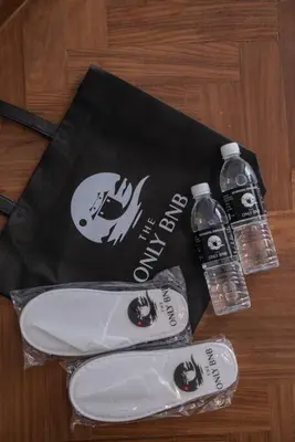 a bag and two bottles of water on a table at Deluxe Seaview Suite Twin Bed by The Only Bnb in Tanjong Tokong