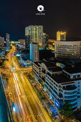 a city lit up at night with traffic on a highway at Deluxe Seaview Suite Twin Bed by The Only Bnb in Tanjong Tokong