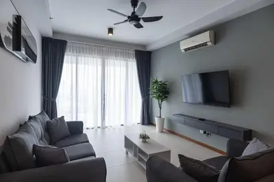 a living room with a couch and a flat screen tv at Family Seaview Suite with 3 Rooms by The Only Bnb in Tanjong Tokong