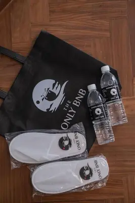 a bag and two bottles of water on a table at Family Seaview Suite with 3 Rooms by The Only Bnb in Tanjong Tokong