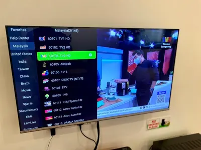 a television screen with a person in a store at comfy 3-bedrooms with family karaoke Max-10pax in Ipoh