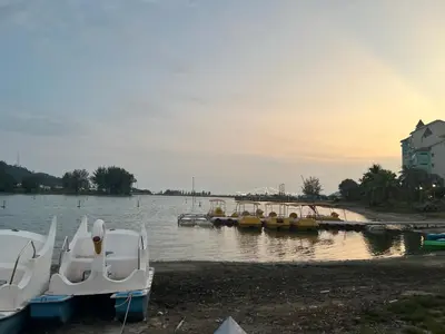 a group of boats are docked on the water at Omari Marina Island Homestay Lumut in Lumut