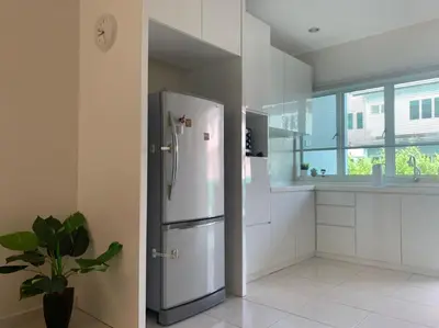 a white kitchen with a refrigerator and a window at Omari Marina Island Homestay Lumut in Lumut