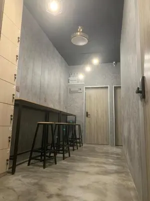 a room with a table and a row of stools at Kota Permai Mini Rest Room 99 Full Equipped in Bukit Mertajam