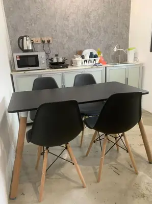 a table with four chairs in a kitchen at Kota Permai Mini Rest Room 99 Full Equipped in Bukit Mertajam