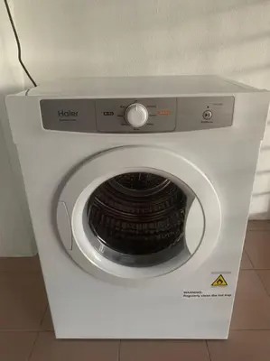 a white washing machine in a box on the floor at Queen Room Bukit Mertajam Alma Impian in Bukit Mertajam