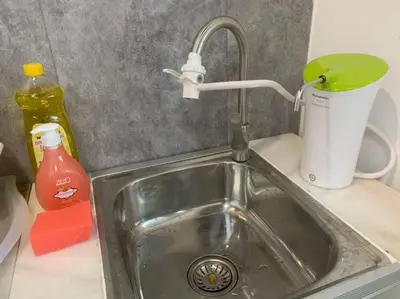 a kitchen sink with a faucet and a cup at Queen Room Bukit Mertajam Alma Impian in Bukit Mertajam