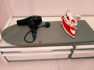 a remote control and a pair of shoes on a table at Preferred30 3R2B 7pax Meritus Perai in Perai