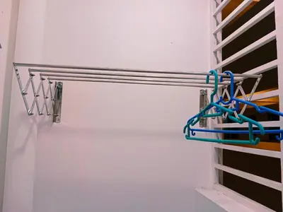 a closet with a white refrigerator with hangers at Preferred30 3R2B 7pax Meritus Perai in Perai
