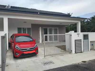a red car parked in front of a house at Abah StayCation in Sungai Besar