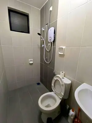 a small bathroom with a toilet and a shower at De cozy 5.0 Double storey (10-16 pax ++) in Ipoh