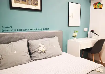 a bedroom with a bed with a desk and a white bedsheet at H2H - CY15 @ Majestic Ipoh in Ipoh