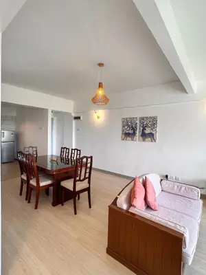 a living room with a couch and a dining room table at The Antler Silverpark Fraser's Hill in Bukit Fraser