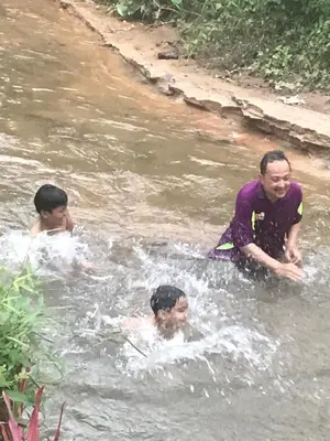 a group of people swimming in a river at Anjung Afilia 1 in Kuala Kangsar
