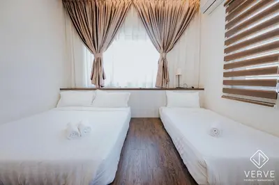 two beds in a room with a window at Ipoh Mansion House 21 by Verve (14pax) EECH74 in Ipoh