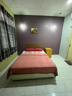 a bedroom with a large bed with a red blanket at RUMAH INAP BANDAR PERDANA in Sungai Petani