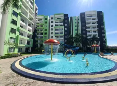a large pool with a water park in front of buildings at Razads Waterpark Homestay Ipoh in Ipoh