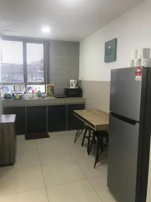 a kitchen with a stainless steel refrigerator and a table at Ipoh Manhattan TSL Pool View Water Park Homestay! in Kampong Pinji