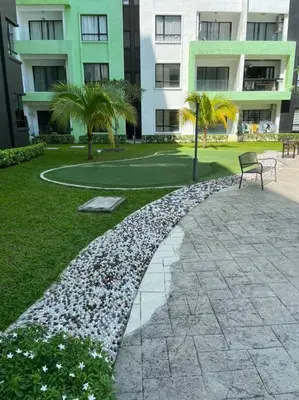 a bench sitting in a park in front of a building at Ipoh Manhattan TSL Pool View Water Park Homestay! in Kampong Pinji