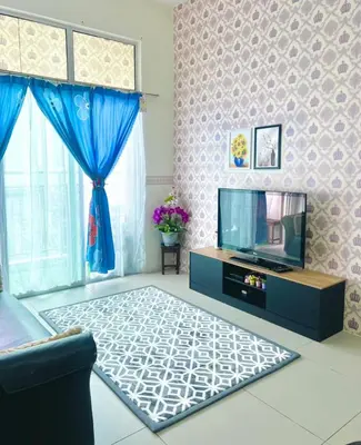 a living room with a tv and a blue curtain at Deq Noor Homestay in Cameron Highlands