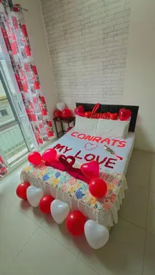 a bed with red and white balloons around it at Deq Noor Homestay in Cameron Highlands