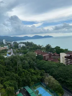 a view of a city and the water with trees at Susies Deluxe Seaview Suite Sri Sayang in Batu Ferringhi