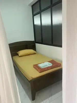 a small bed in a room with a window at Susies Deluxe Seaview Suite Sri Sayang in Batu Ferringhi