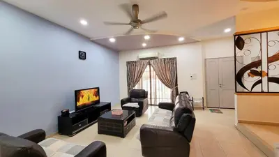 a living room with couches and a flat screen tv at JackBeansprouts Homestay Botani Ipoh in Ipoh