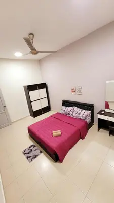 a bedroom with a large bed with a red blanket at JackBeansprouts Homestay Botani Ipoh in Ipoh