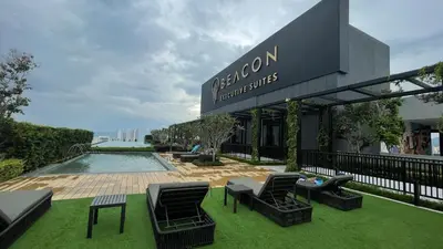 a resort with a pool and chairs and a building at #12Georgetown Luxury Suite with Rooftop Pool in George Town