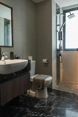 a bathroom with a sink and a toilet and a shower at Elegant Seaview Projector Lounge by The Only Bnb in Tanjong Tokong