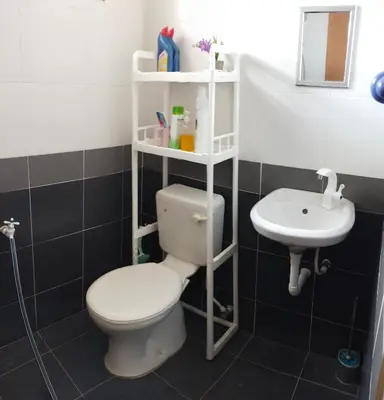 a bathroom with a toilet and a sink at WAFID HOMESTAY SERI ISKANDAR in Seri Iskandar