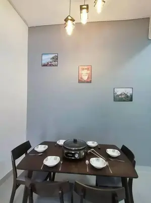 a dining room table with a pot and plates and chairs at Cameron top31 golden hills night market homestay in Brinchang