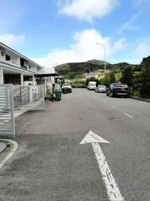 a parking lot with cars parked on the side of a road at Cameron top31 golden hills night market homestay in Brinchang