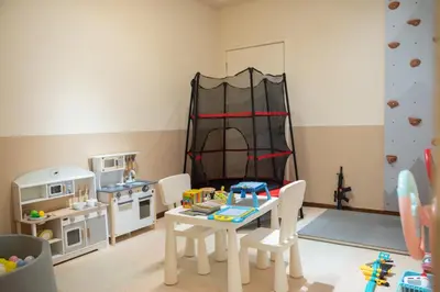 a toy kitchen with a table and chairs and a play set at Fantasy Funland Retreat by The Only Bnb in Tanjong Tokong