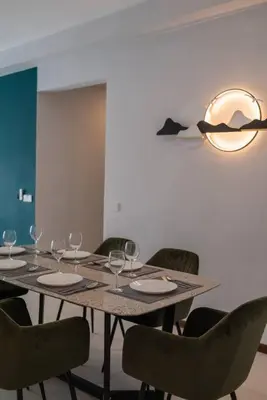 a dining room table with chairs and a light fixture at Family Seaview Suite with 3 Rooms by The Only Bnb in Tanjong Tokong
