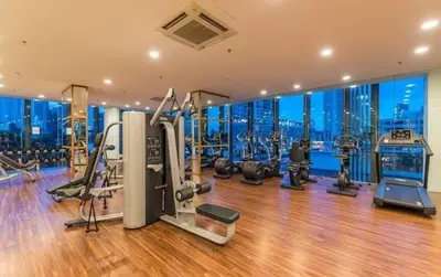 a gym with exercise equipment and a view of the city at Family Seaview Suite with 3 Rooms by The Only Bnb in Tanjong Tokong