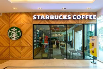 a starbucks coffee store with a sign on the wall at 2R2B/Cosy House/1~8pax/Gurney/Mansion One in George Town
