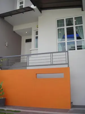 an orange front door of a house at Shamrock Beach Villas Batu Ferringhi Penang in Batu Ferringhi