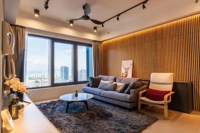 a living room with a couch and a chair at Executive Seaview 2Bedrooms Macalister Georgetown 4-6pax in George Town